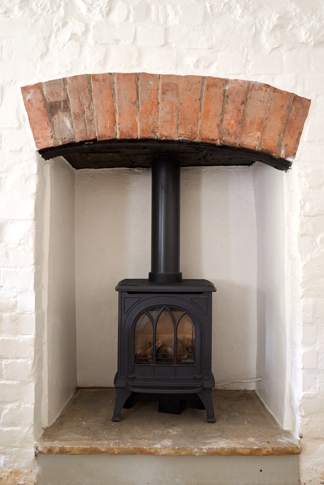 Cosy cottage fireplace with warm evening glow